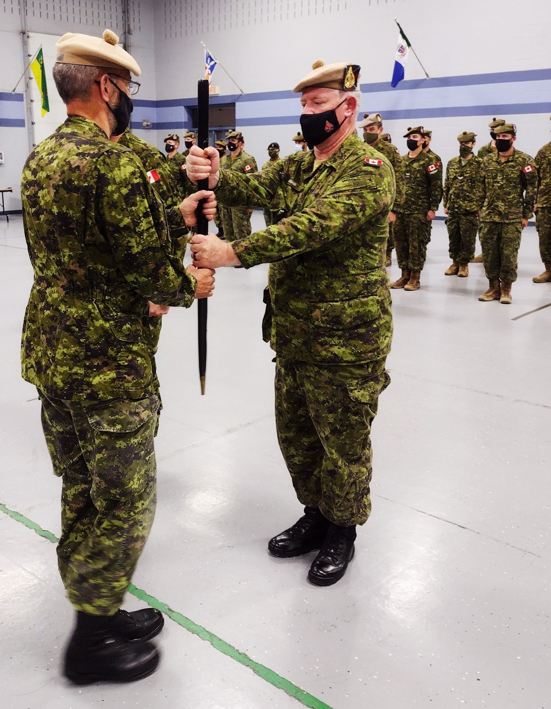 Outgoing RSM, CWO Brian Jordan hands pace stick to CO, LCol Gord Prentice