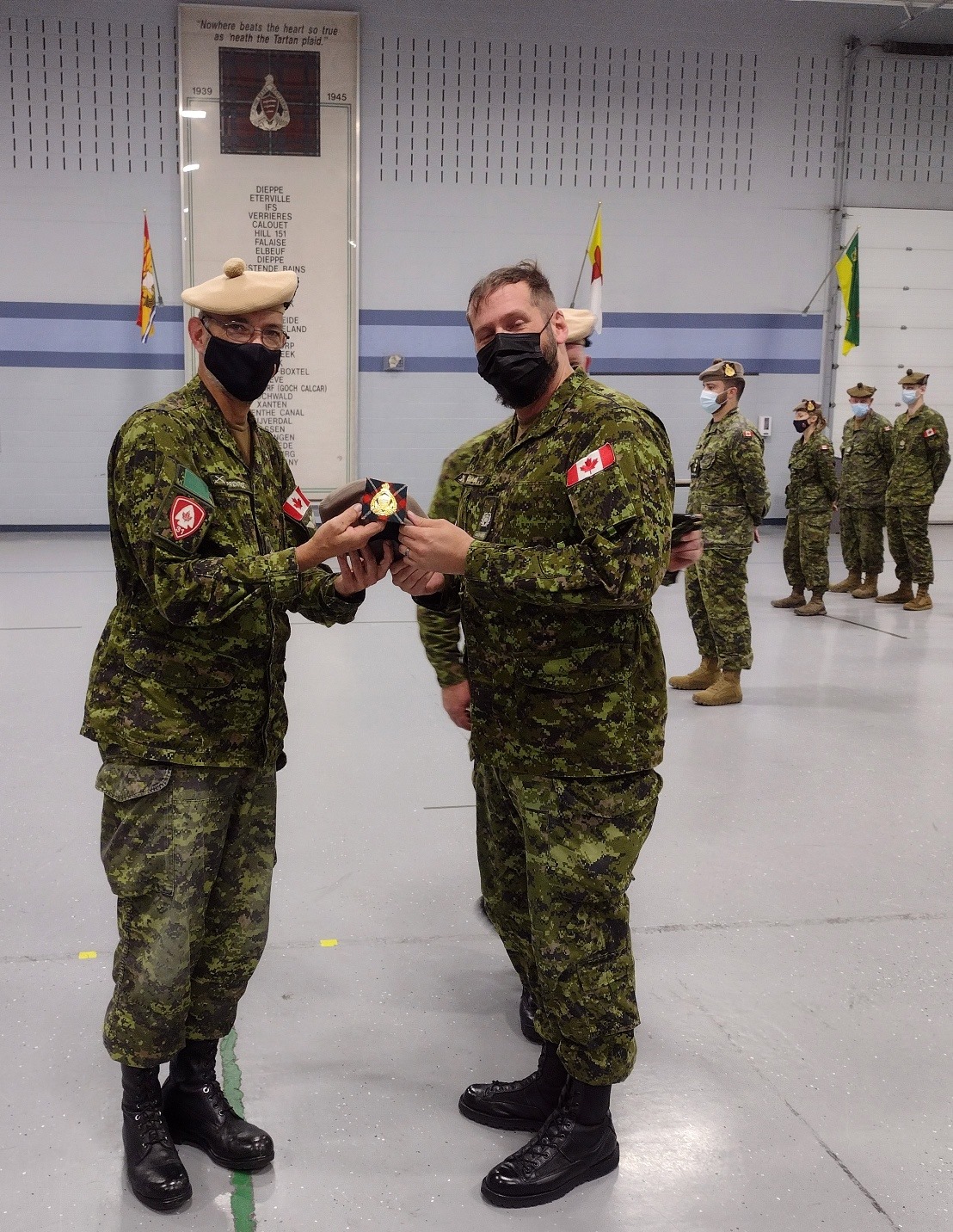 MWO Jeremy Clark (right) is badged into E&K Scot by CO, LCol Gord Prentice, then promoted to CWO.